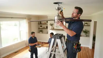 Electrician installing a ceiling fan in an Orange, CA home