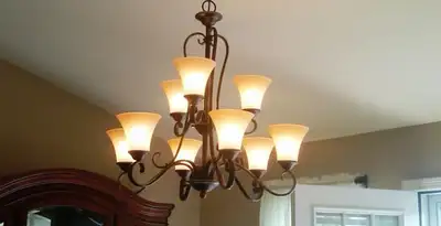 Classic ceiling chandelier installation with warm lighting in Orange, CA