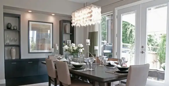 Elegant dining room chandelier installation above table in Orange, CA