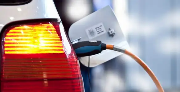 Electric car plugged into EV charger after professional installation in Orange, CA