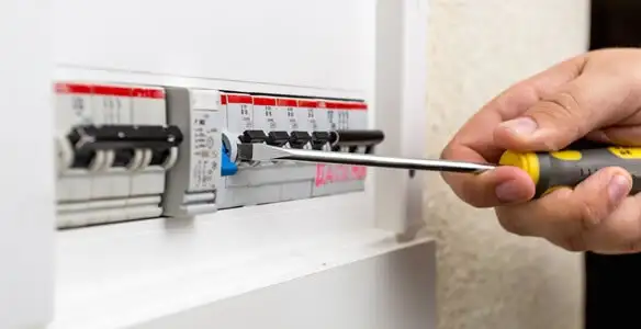 electrical panel upgrade service showing technician adjusting circuit breakers during system upgrade in Orange, CA