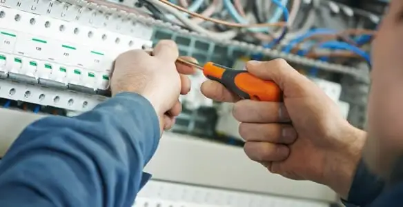 electrical service showing licensed electrician performing electrical panel maintenance and adjustments in Orange, CA
