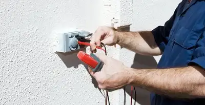 Electrician performing home electrical outlet and wiring inspection in Orange, CA