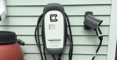 Outdoor electric vehicle charger installation on residential wall in Orange, CA