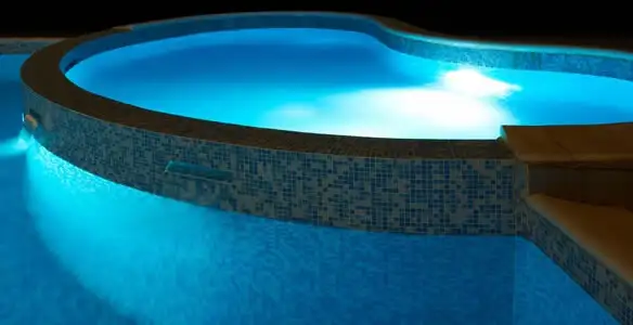 pool light installation and repair services highlighting illuminated pool interior lighting in Orange, CA