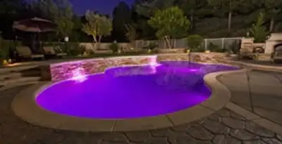 pool light installation and repair services illuminating a residential swimming pool in Orange, CA