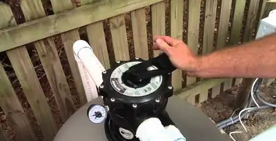 pool pumps service showing professional adjustment of pool pump control system in Orange, CA