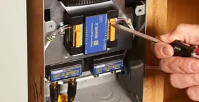 Whole home surge protection device being installed by a licensed electrician to protect electrical systems in Orange, CA